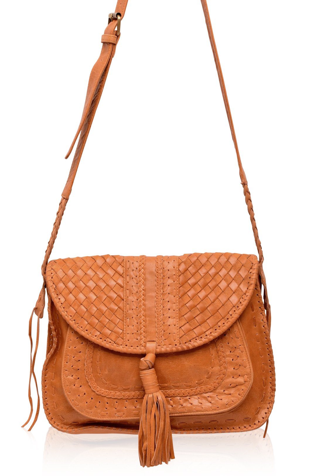 Tan vintage leather woven handbag with a tassel and long adjustable strap on a white background