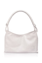 White handbag with a textured handle on a white background