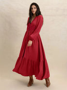 Scarlett Grace Button Front Maxi Dress in deep scarlet red — 3/4 view showing dress movement and drape.