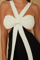 Close-up detail of bow-front halter neckline in black and white fabric

