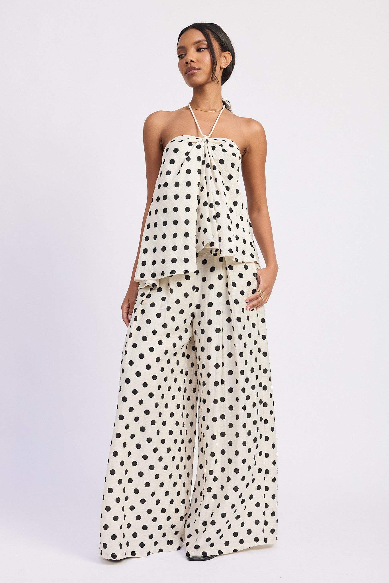 Ivory polka dot halter top paired with matching wide-leg pants, full look
