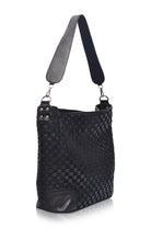 Side view of the black Soho Lane Woven Leather Shoulder Bag with wide leather shoulder strap
