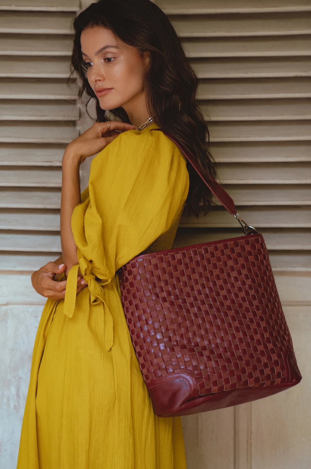 Model wearing the Soho Lane Woven Leather Shoulder Bag in maroon handcrafted genuine leather
