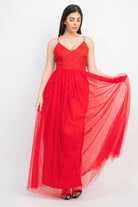 Model wearing red tulle maxi dress with sparkle straps