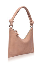 Beige leather handbag with silver hardware and knotted leather handle on a white background