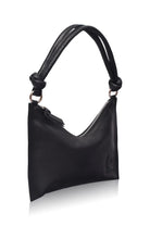 leather handbag with silver hardware and knotted leather handle on a white background