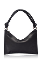 Black leather handbag with silver hardware and knotted leather handle on a white background