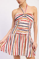 Woman wearing a striped halter mini dress front view with multicolor vertical stripes on a white background front view closeup