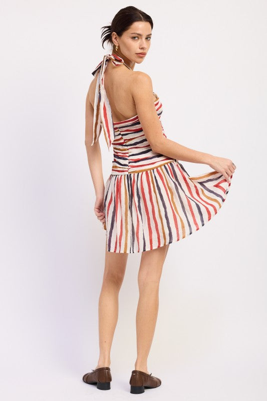 Woman wearing a striped halter mini dress front view with multicolor vertical stripes on a white background back view