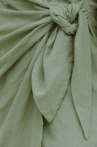Closeup of fabric of sherbert green crinkle linen mini dress 