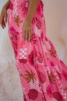 Close-up of a pink dress with shell pattern on a textured surface