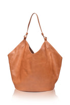 Tan soft leather handbag on a white background, front view