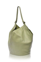 Green soft leather handbag with single leather handle on a white background, side view