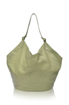 Green soft leather handbag with a handle on a white background, front view