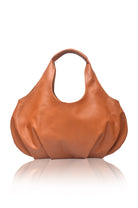 Large tan leather handbag on a white background, front view
