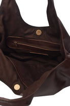 Dark brown suede interior of a dark chocolate brown leather handbag with gold snap and interior zipper pouch on a white background