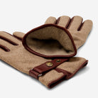 Pair of brown gloves with leather accents on a white background