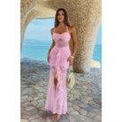 Pink Tide Lace Halter Maxi Dress in pink lace with a halter neckline, ruched front, sheer lace panels, cascading ruffle detail, front slit, and fitted maxi silhouette.