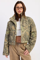 Wildwood camo puffer jacket with woodland print, oversized stand collar and snap front closure, front view.