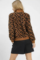 Back view of Wildwood Leopard Sherpa Quarter Zip Pullover in camel and black leopard print with ribbed hem and cuffs.