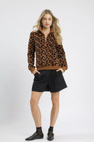 Wildwood Leopard Sherpa Quarter Zip Pullover in camel and black with high collar and ribbed trim, full front view.