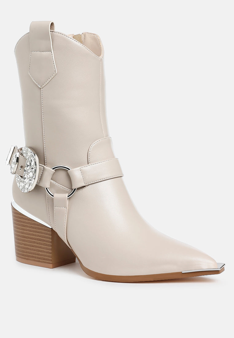 Angled front view of beige Rodeo Romance Western Ankle Boots featuring jeweled buckle, silver harness hardware and pointed toe.