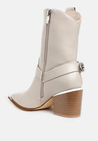 Rear angled view of beige Rodeo Romance Western Ankle Boots showing side zipper, pull tab, stacked look block heel and harness strap.