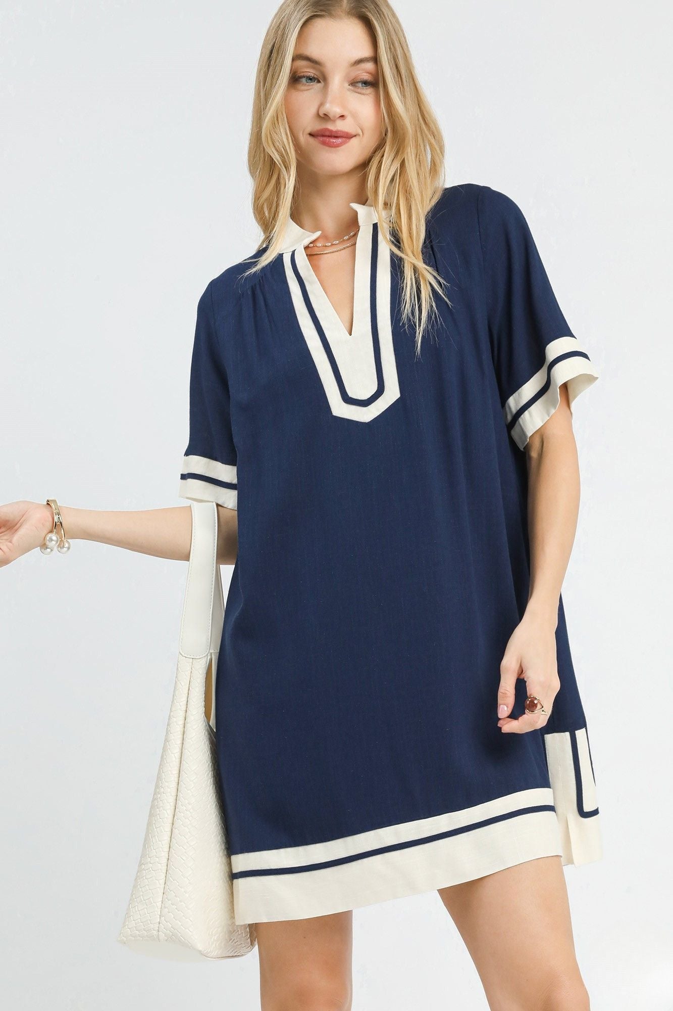 Three quarter view of navy contrast trim linen mini dress with relaxed shift silhouette, AVAH