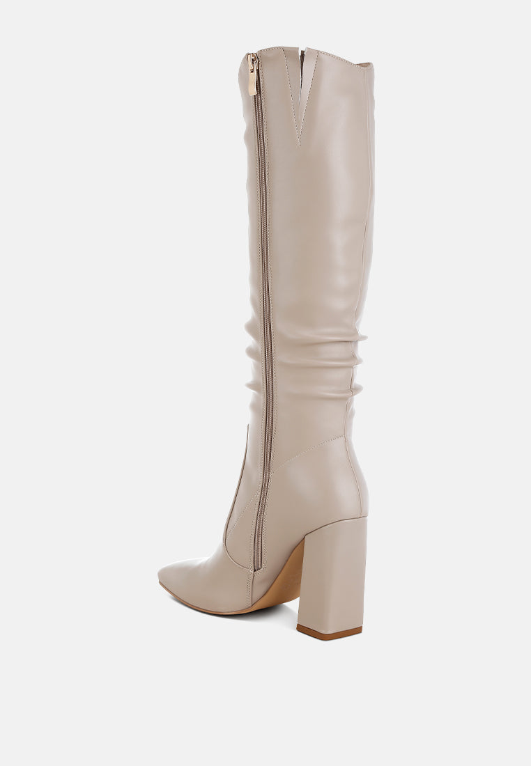 Back angled view of beige Vienna Sculpted Heel Knee High Boots showing side zipper closure, gathered shaft and block heel.