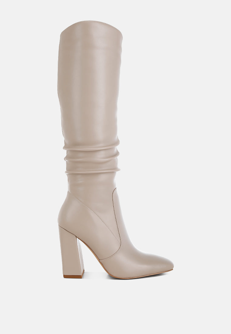 Vienna Sculpted Heel Knee High Boots in beige faux leather with subtle slouch detailing, square toe and 4 inch block heel, side view.