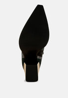 Black high-heeled shoe with a pointed toe on a white background