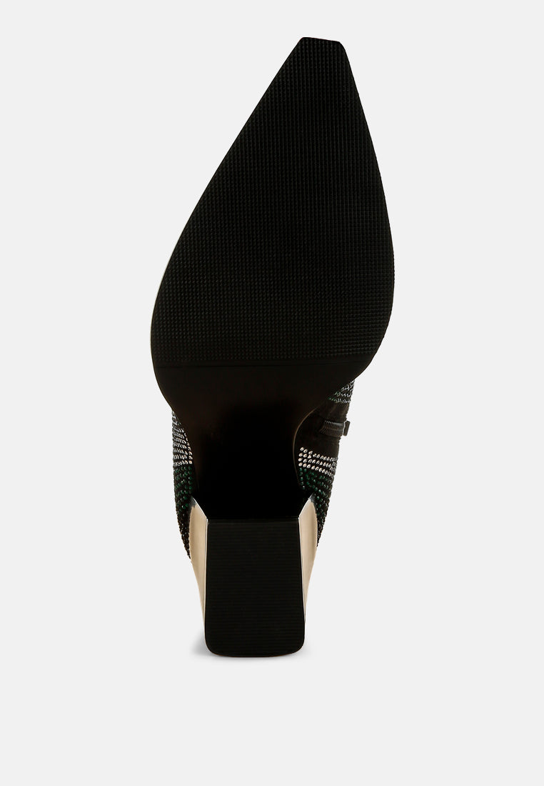 Black high-heeled shoe with a pointed toe on a white background
