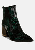 Black ankle boots with green rhinestone detailing on a white background