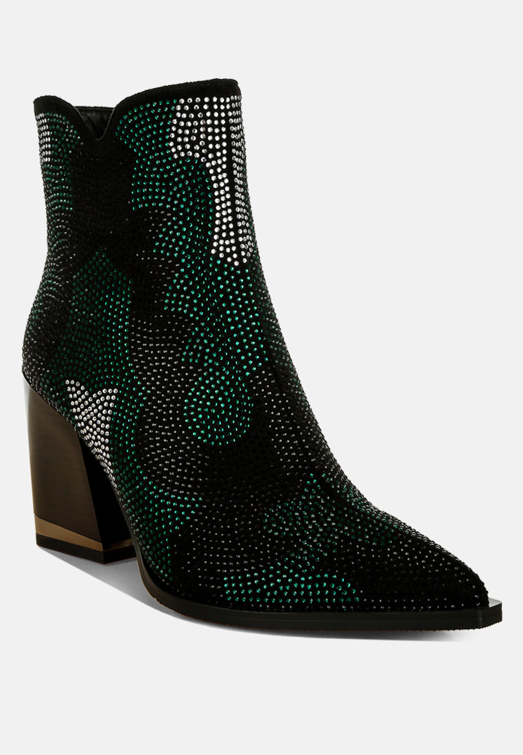 Black ankle boots with green rhinestone detailing on a white background