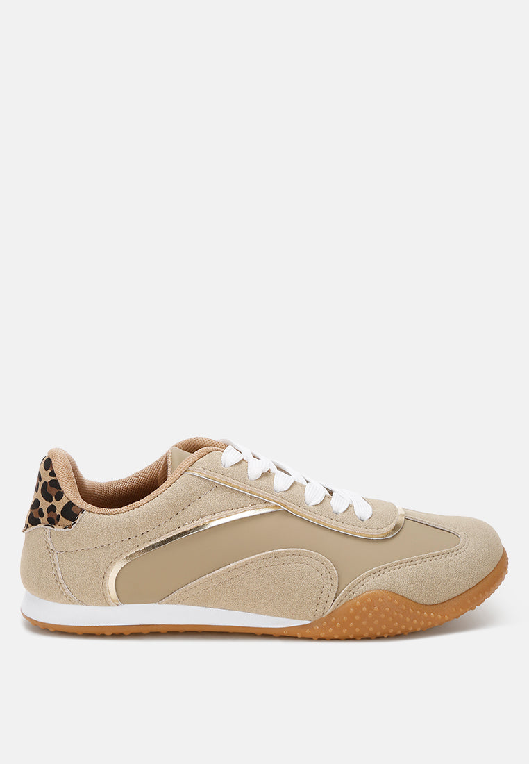 Beige sneaker with leopard print and metallic accents on a white background
