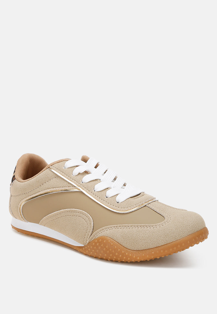 Beige sneaker with leopard print and metallic accents on a white background, side view
