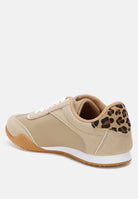Beige sneaker with leopard print and metallic accents on a white background, back view