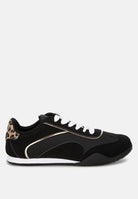 Black sneaker with leopard print and metallic accents on a white background, side view