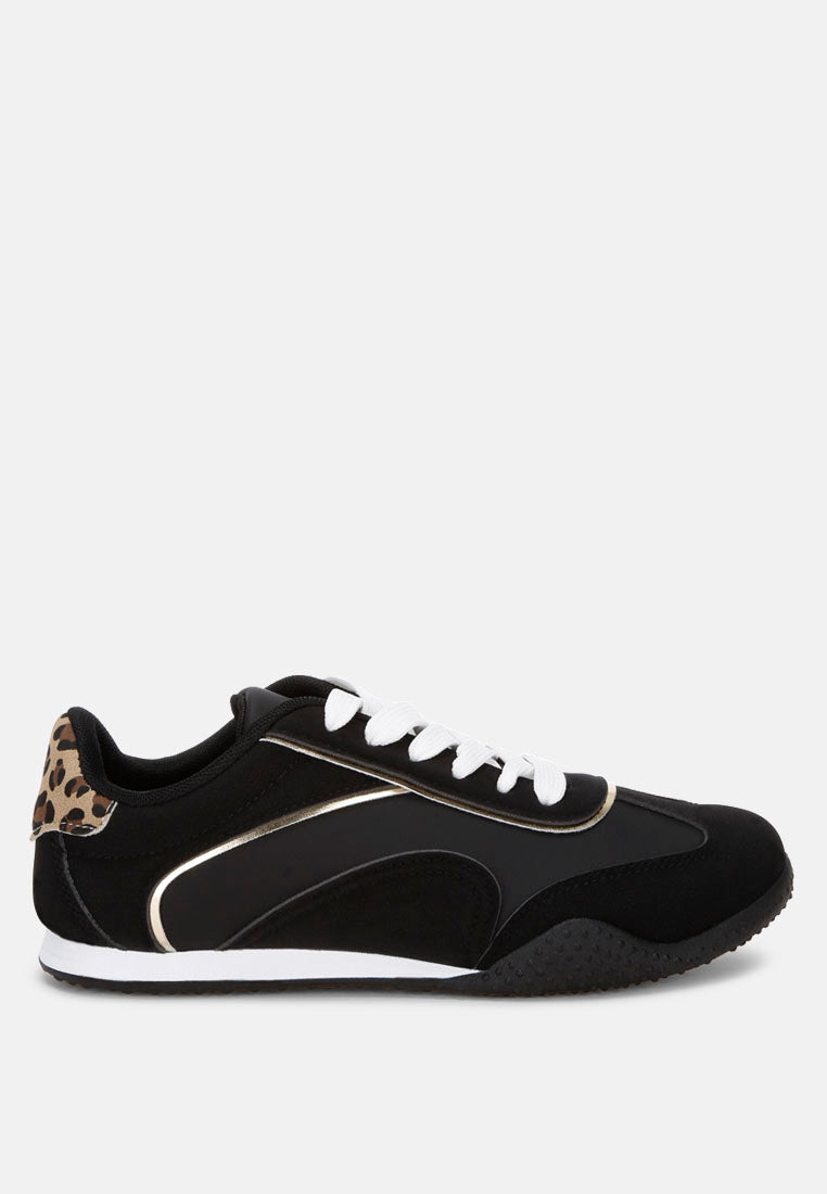 Black sneaker with leopard print and metallic accents on a white background, side view