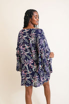 Back view of navy kimono with pastel floral leaf print, styled with a relaxed silhouette.