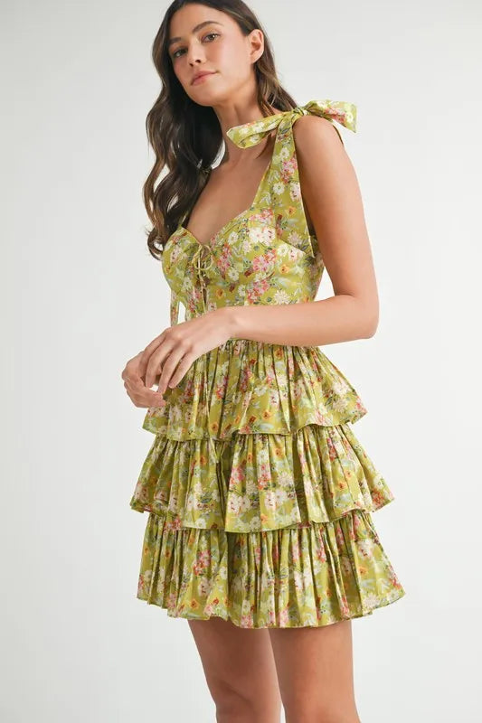Side view of lime green floral tiered mini dress with layered ruffle skirt
