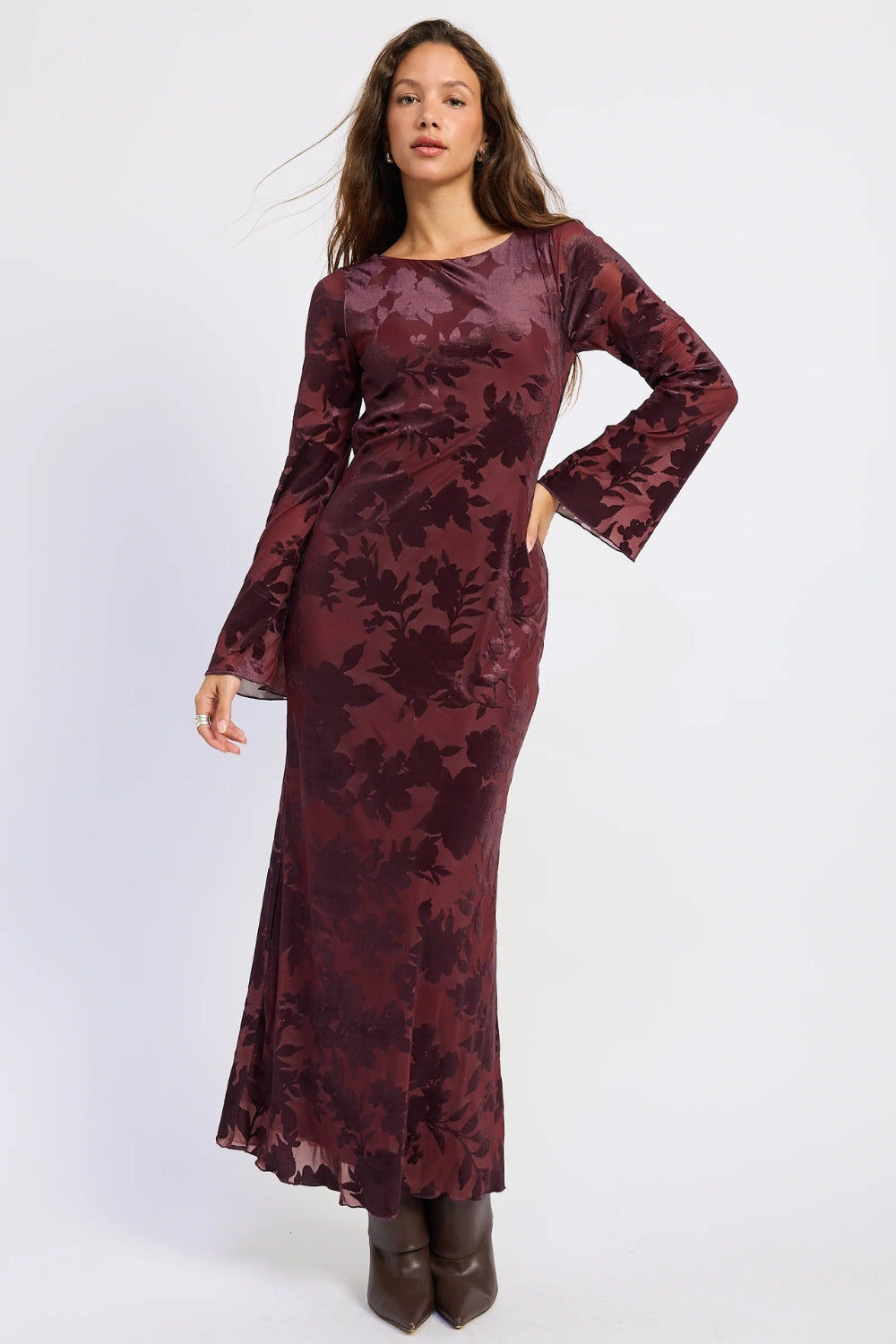 Woman wearing a burgundy floral long sleeve maxi dress