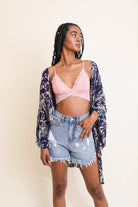 Navy leaf print kimono styled with denim shorts and lace bralette for a casual boho look.