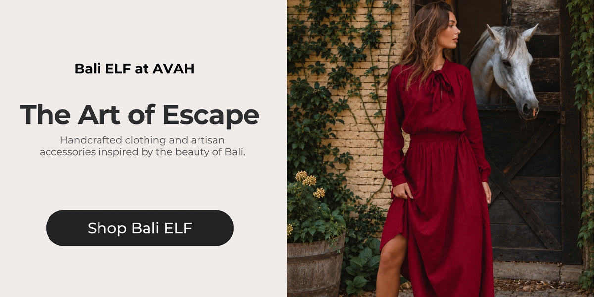 Woman wearing a deep red Bali ELF dress beside a white horse