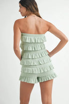 Back view of sage green smocked romper
