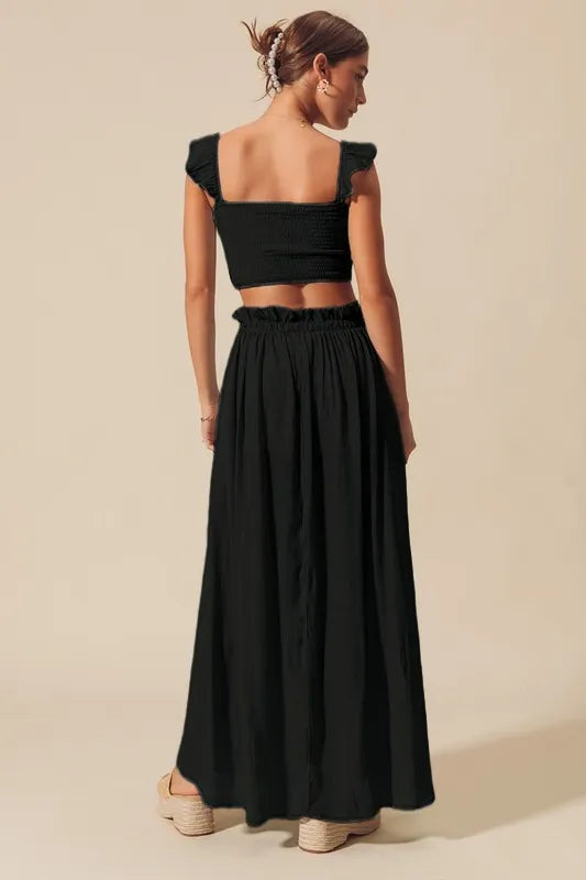 Back view of black smocked crop top and maxi skirt matching set
