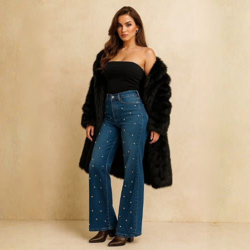 Model wearing a black faux fur coat with pearl-embellished wide-leg jeans for winter fashion – AVAH.