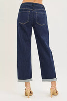 Dark indigo cuffed wide leg jeans showing back pockets and wide leg fit
