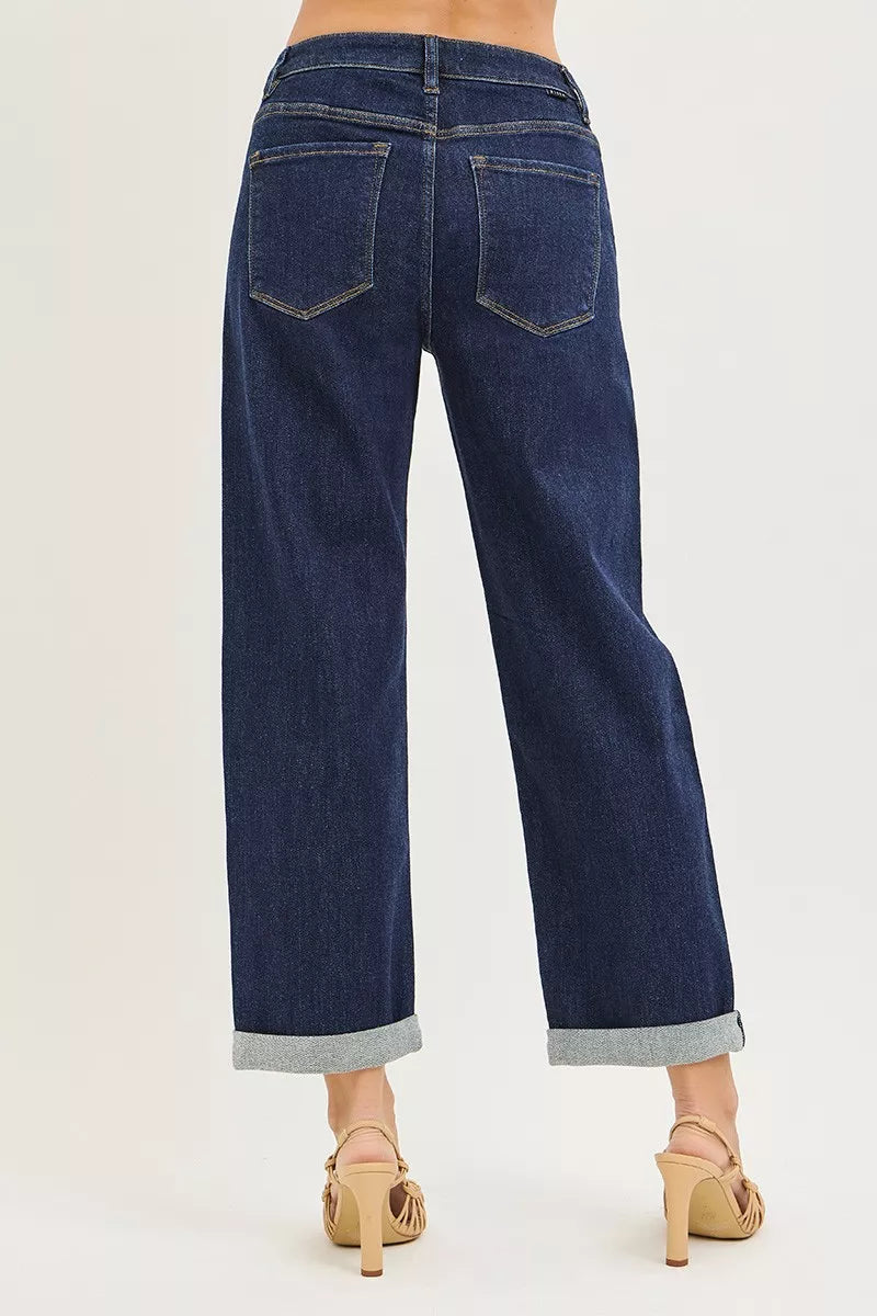 Dark indigo cuffed wide leg jeans showing back pockets and wide leg fit
