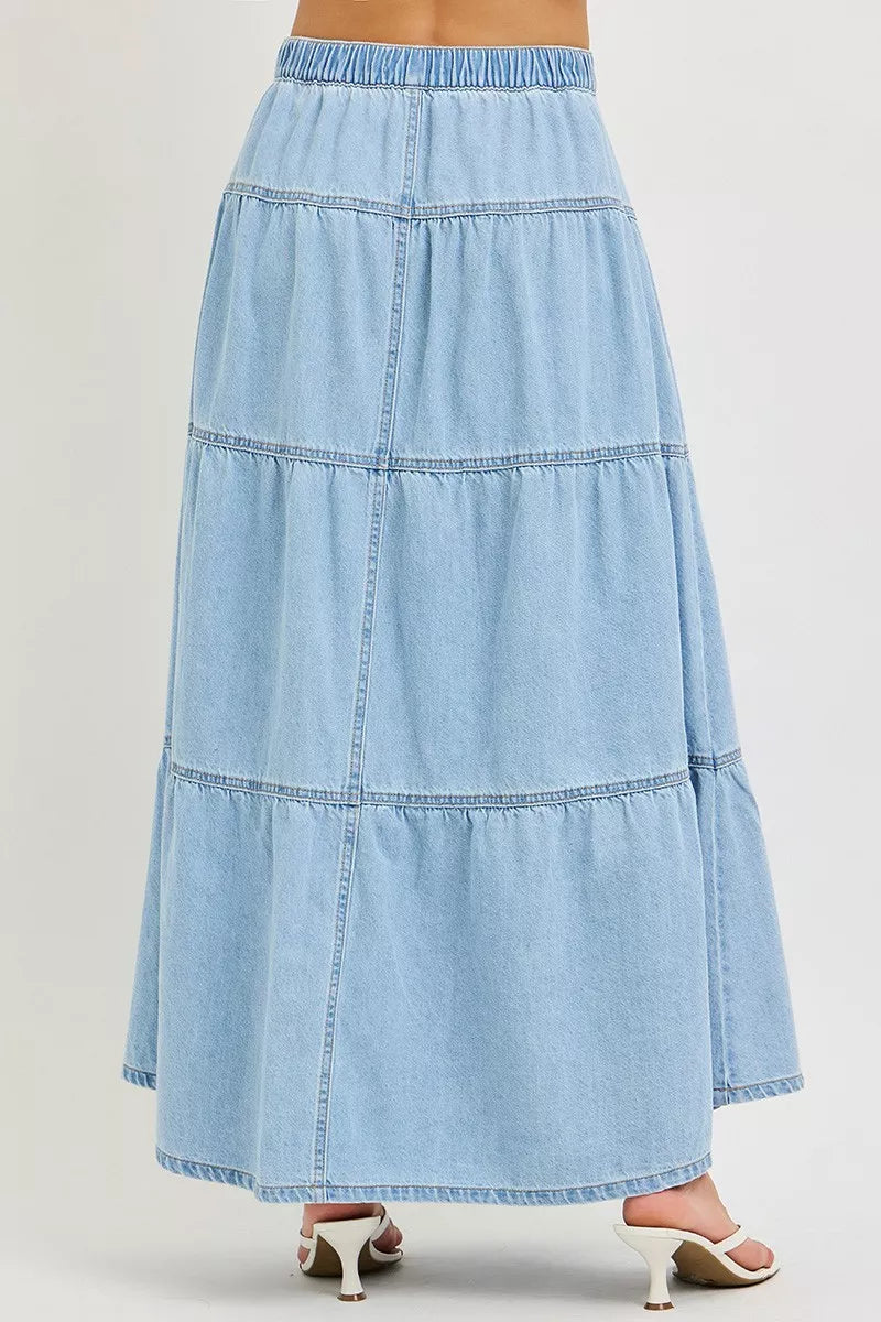 Back view of tiered light wash denim maxi skirt with elastic waistband
